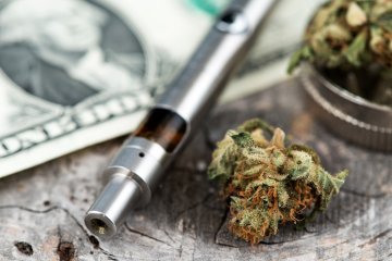 Cannabis vaporizer on a dollar bill for vaping herbs Cannabis vaporizer on a dollar bill for vaping herbs